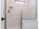 Elegant walk-in shower featuring marbled tile and a glass door for a bright, modern bathroom at 155 Gaines Trl, Pittsboro, NC 27312