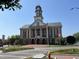 Brick courthouse in a town square with American flag and surrounding businesses at 155 Gaines Trl, Pittsboro, NC 27312