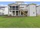 Back exterior showcasing a large lawn and screened porch at 2518 Silas Peak Ln, Apex, NC 27523