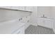 Bright laundry room featuring white cabinets and patterned tile floor at 2518 Silas Peak Ln, Apex, NC 27523