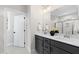 Modern bathroom with dual vanity, quartz countertop, and large mirror at 106 Wichita Way, Louisburg, NC 27549