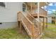 Wood stairs lead to a cozy outdoor space, perfect for enjoying the backyard at 148 Harmony Trl, Broadway, NC 27505