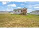 View of the home and expansive backyard with freshly seeded lawn, perfect for recreation at 148 Harmony Trl, Broadway, NC 27505