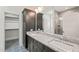 A bathroom featuring double vanities with granite countertop, decorative tile floor, and walk-in shower at 148 Harmony Trl, Broadway, NC 27505