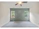 Bedroom with carpet, ceiling fan and a green accent wall at 148 Harmony Trl, Broadway, NC 27505