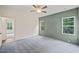Spacious bedroom with green accent wall, carpet, and abundant natural light at 148 Harmony Trl, Broadway, NC 27505