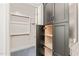 A walk-in closet with wood shelves and clothes rods, next to an additional storage cabinet at 148 Harmony Trl, Broadway, NC 27505