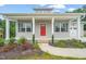 Charming home featuring a red front door, gray siding, and well-manicured landscaping at 148 Harmony Trl, Broadway, NC 27505
