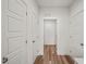 Hallway featuring hardwood floors and white doors at 148 Harmony Trl, Broadway, NC 27505