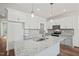 Bright kitchen with stainless steel appliances, gray cabinets, and a granite island with a sink at 148 Harmony Trl, Broadway, NC 27505
