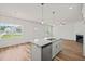 Open concept kitchen with large windows, granite island with seating, and stainless steel appliances at 148 Harmony Trl, Broadway, NC 27505