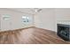 Bright living room with hardwood floors, a ceiling fan, fireplace and an abundance of natural light at 148 Harmony Trl, Broadway, NC 27505