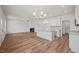 Open-concept living space with hardwood floors, fireplace, and a view into the kitchen area at 148 Harmony Trl, Broadway, NC 27505