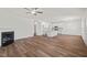 Open-concept living space with hardwood floors, fireplace, and a view into the kitchen area at 148 Harmony Trl, Broadway, NC 27505