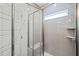 A tile shower behind glass doors with a built-in seat and window at 148 Harmony Trl, Broadway, NC 27505