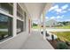 Exterior side view featuring a long concrete porch and white pillars, with a home in the background at 148 Harmony Trl, Broadway, NC 27505