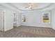 Spacious main bedroom features tray ceiling, neutral walls, carpet and a large window for natural light at 106 Burnello Ct, Princeton, NC 27569