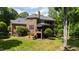 Lush backyard with a large home and covered porch at 1820 Oatlands Court Ct, Wake Forest, NC 27587