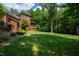 Beautifully landscaped backyard with mature trees and lush green lawn at 1820 Oatlands Court Ct, Wake Forest, NC 27587