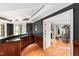 Entertainer's bar featuring a wet bar, wood cabinets, and views of the exercise area at 1820 Oatlands Court Ct, Wake Forest, NC 27587