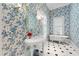 Elegant bathroom featuring floral wallpaper, clawfoot tub, and pedestal sink at 1820 Oatlands Court Ct, Wake Forest, NC 27587