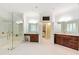 Expansive bathroom featuring a walk-in glass shower, marble floors, and and wooden vanities at 1820 Oatlands Court Ct, Wake Forest, NC 27587