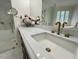 Bright bathroom featuring marble counters, gold fixtures, glass enclosed shower and tub at 1820 Oatlands Court Ct, Wake Forest, NC 27587