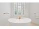 Bright bathroom with a standalone tub, plantation shutters, and modern gold fixtures at 1820 Oatlands Court Ct, Wake Forest, NC 27587