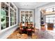 Bright breakfast nook with a round table, large windows and slate floors at 1820 Oatlands Court Ct, Wake Forest, NC 27587