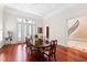 Formal dining room with hardwood floors, large windows, and elegant table, ideal for hosting dinners and special occasions at 1820 Oatlands Court Ct, Wake Forest, NC 27587