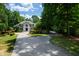 Stately brick home featuring a grand entrance, manicured lawn, and a long winding driveway, perfect for an impressive residence at 1820 Oatlands Court Ct, Wake Forest, NC 27587