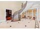 Elegant foyer showcasing a curved staircase, marble floors, and a view into the formal living area with stately columns at 1820 Oatlands Court Ct, Wake Forest, NC 27587
