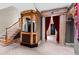 Luxurious foyer featuring a staircase, vintage ticket booth, and theatrical accents for a dramatic effect at 1820 Oatlands Court Ct, Wake Forest, NC 27587