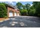 Spacious three-car garage with ample parking space and traditional brick exterior at 1820 Oatlands Court Ct, Wake Forest, NC 27587