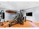 Home gym with modern exercise equipment, surfboard, and ample space for workouts at 1820 Oatlands Court Ct, Wake Forest, NC 27587