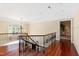 Bright hallway with hardwood floors, chandelier, and decorative wrought iron railing leading to upstairs rooms at 1820 Oatlands Court Ct, Wake Forest, NC 27587