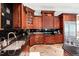 Well-appointed kitchen featuring custom cabinets, granite countertops, and modern appliances, offering a stylish and functional space at 1820 Oatlands Court Ct, Wake Forest, NC 27587