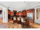 Gourmet kitchen featuring custom wood cabinetry, a large island, and stainless steel appliances at 1820 Oatlands Court Ct, Wake Forest, NC 27587