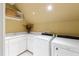 Convenient laundry room with ample counter space, sink, storage, and modern white washer and dryer at 1820 Oatlands Court Ct, Wake Forest, NC 27587