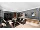 Spacious living room with leather seating, movie posters, and an arched entry at 1820 Oatlands Court Ct, Wake Forest, NC 27587