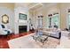 Comfortable living room featuring a fireplace, large windows, and plush seating, perfect for relaxation and social gatherings at 1820 Oatlands Court Ct, Wake Forest, NC 27587