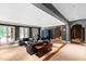 Spacious living room boasts neutral walls, french doors, dark gray trim and travertine flooring at 1820 Oatlands Court Ct, Wake Forest, NC 27587