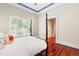 Bright main bedroom with a four-poster bed and large windows at 1820 Oatlands Court Ct, Wake Forest, NC 27587