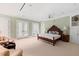 Spacious main bedroom with a seating area, a ceiling fan, plush carpet, and lots of natural light at 1820 Oatlands Court Ct, Wake Forest, NC 27587
