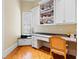 Bright home office featuring custom built-ins, hardwood floors, and ample desk space at 1820 Oatlands Court Ct, Wake Forest, NC 27587