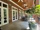 Outdoor patio dining set with brick columns and ceiling fans at 1820 Oatlands Court Ct, Wake Forest, NC 27587