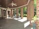 Covered brick patio perfect for outdoor entertaining, showcasing plants and greenery at 1820 Oatlands Court Ct, Wake Forest, NC 27587