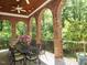 Spacious patio and backyard with brick arches, wood ceiling, and ceiling fan at 1820 Oatlands Court Ct, Wake Forest, NC 27587