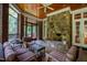 Inviting screened porch with a stone fireplace and outdoor seating area at 1820 Oatlands Court Ct, Wake Forest, NC 27587