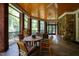 Relaxing screened porch with a round dining table and wood ceilings at 1820 Oatlands Court Ct, Wake Forest, NC 27587